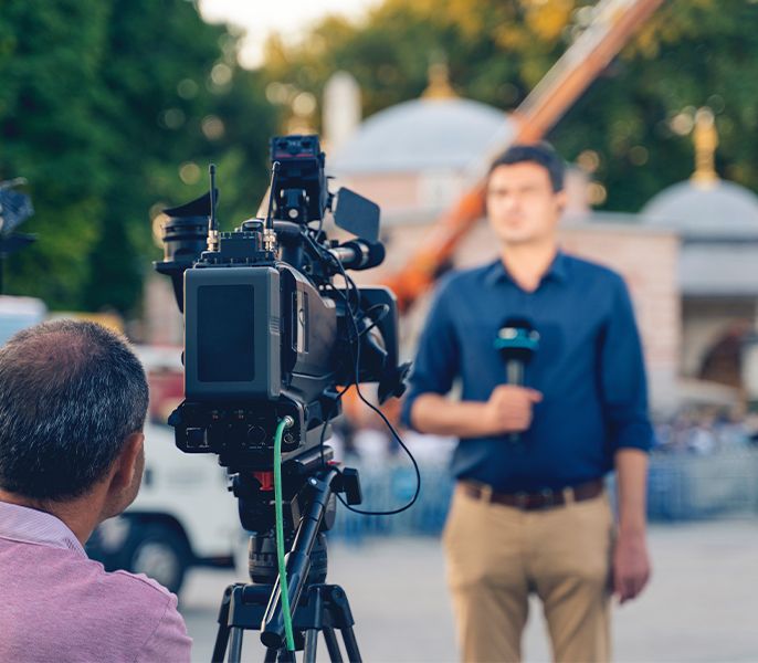 A Spectrum Networks camera crew and reporter working on location