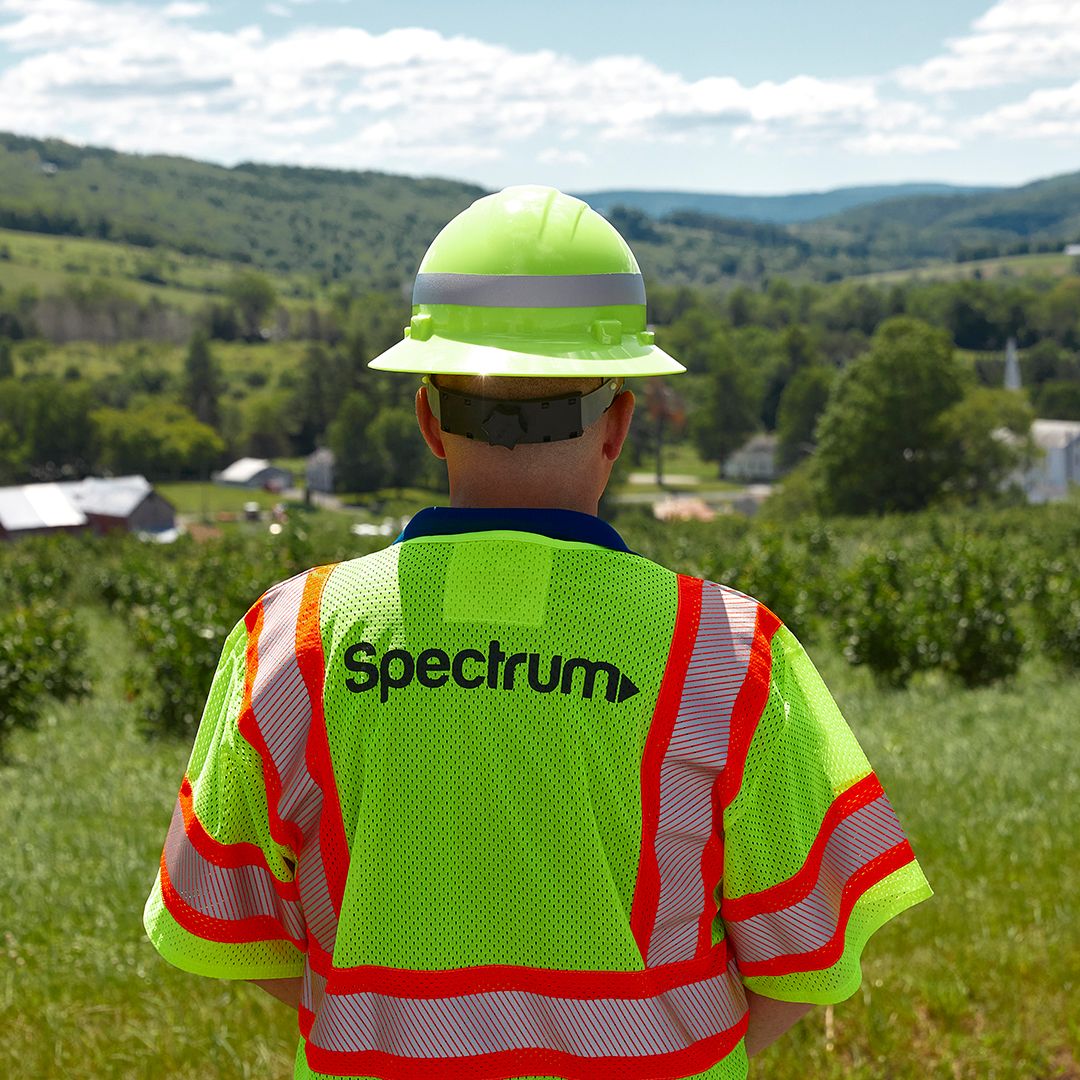 Spectrum technician looking out over a valley